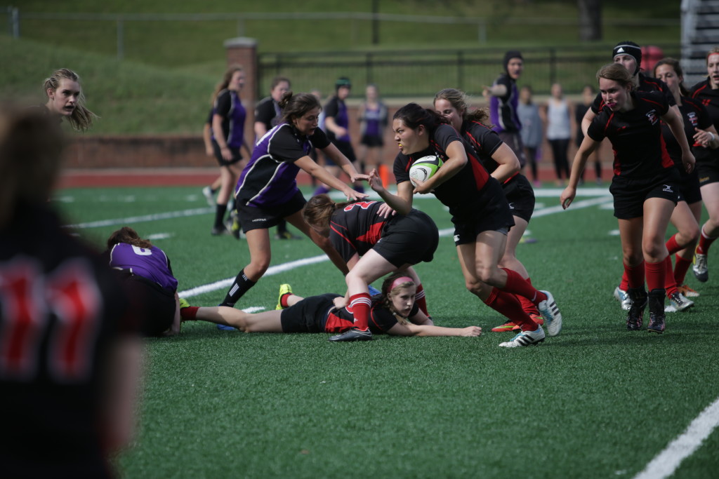 Jen Vo ‘16 picks up the ball with a parade of help from behind. Vo had two tries in the 50-0 win. 