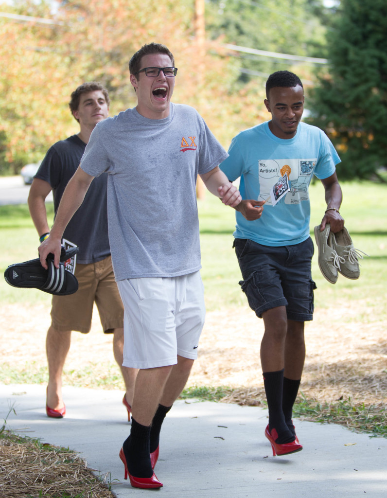 Davis Cameron ‘18, pictured above, among other participants walked a mile from the Granville Inn to Lamson Lodge wearing bright red high heels. Walk a Mile in Her Shoes raises awareness about sexual assault and violence against women. 